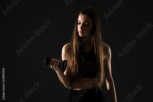 Young sport woman making weightlifting