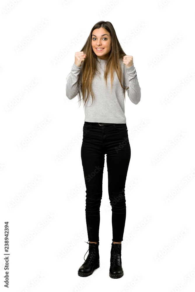 Full-length shot of young girl celebrating a victory in winner position on isolated white background Full-length shot of young girl celebrating a victory in winner position on isolated white background
