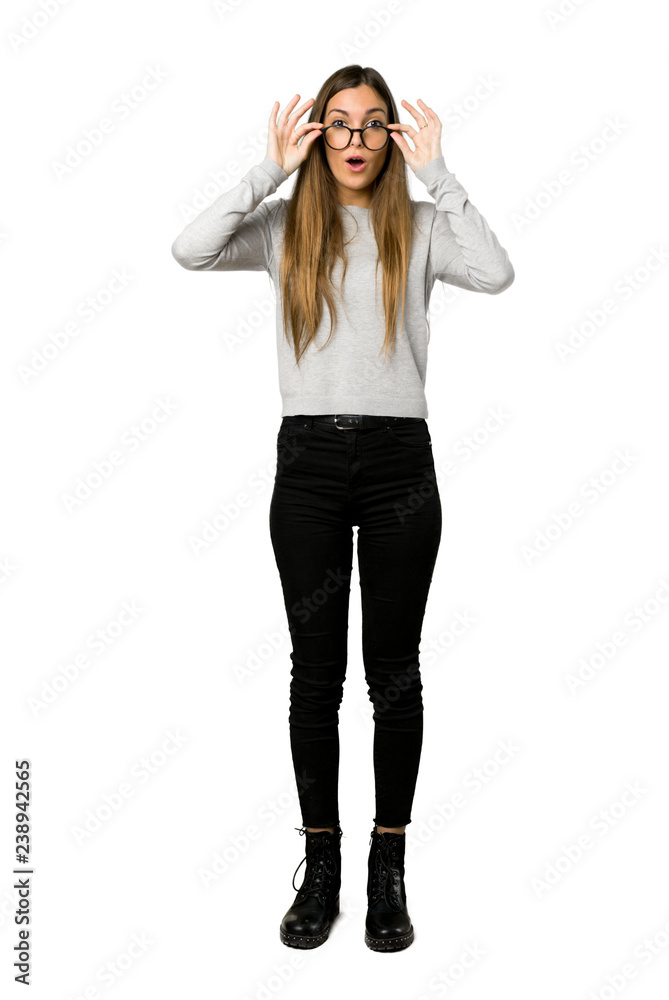 Full-length shot of young girl with glasses and surprised on isolated white background Full-length shot of young girl with glasses and surprised on isolated white background