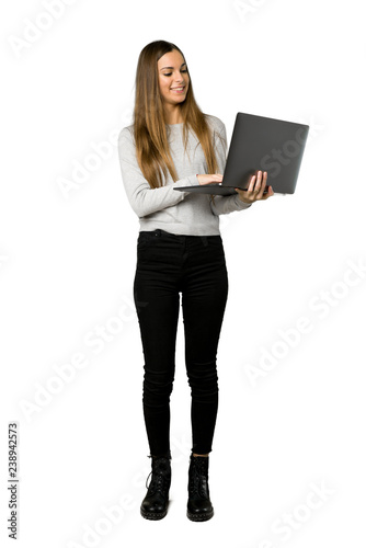 Full-length shot of young girl with laptop on isolated white background