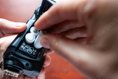 Replacing the AA battery in the on-camera flash photo
