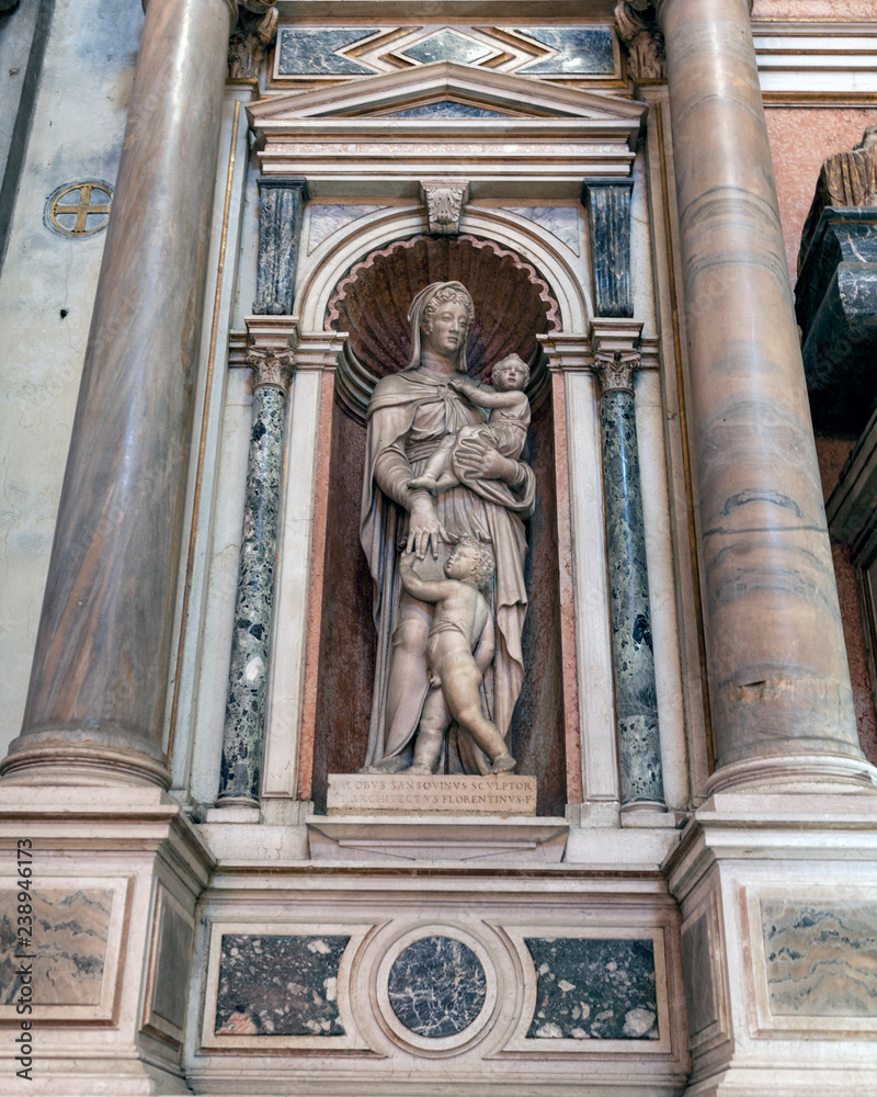 Statue of Madonna and child with John the Baptist