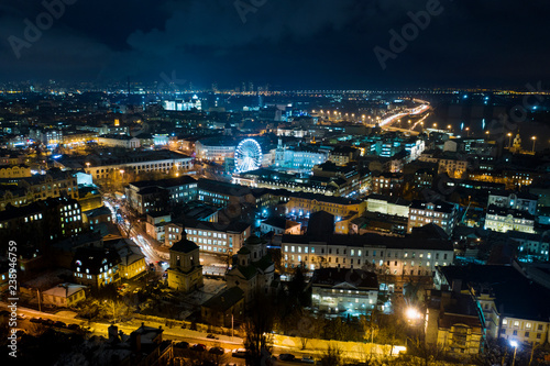 Night cityscape of Kiev. View of Podil with ferris wheel in the center