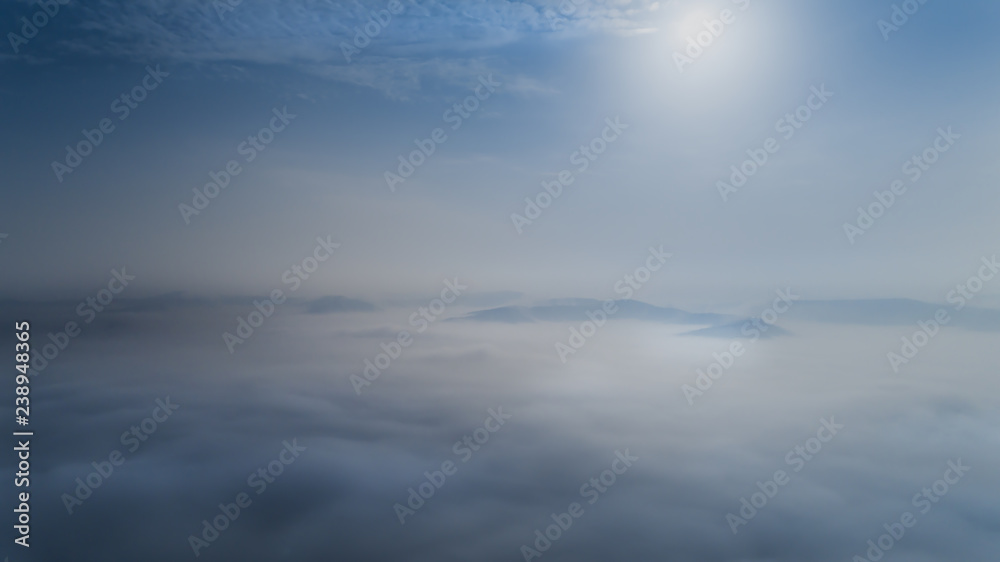 Aerial view from a drone about the Transylvanian valleys on a foggy morning, above Sic village, Transylvania,  Romania