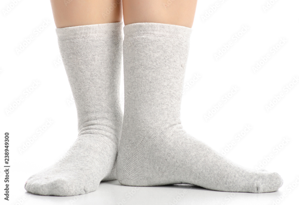 Female legs in gray socks on white background. Isolation Female legs in gray socks on white background. Isolation