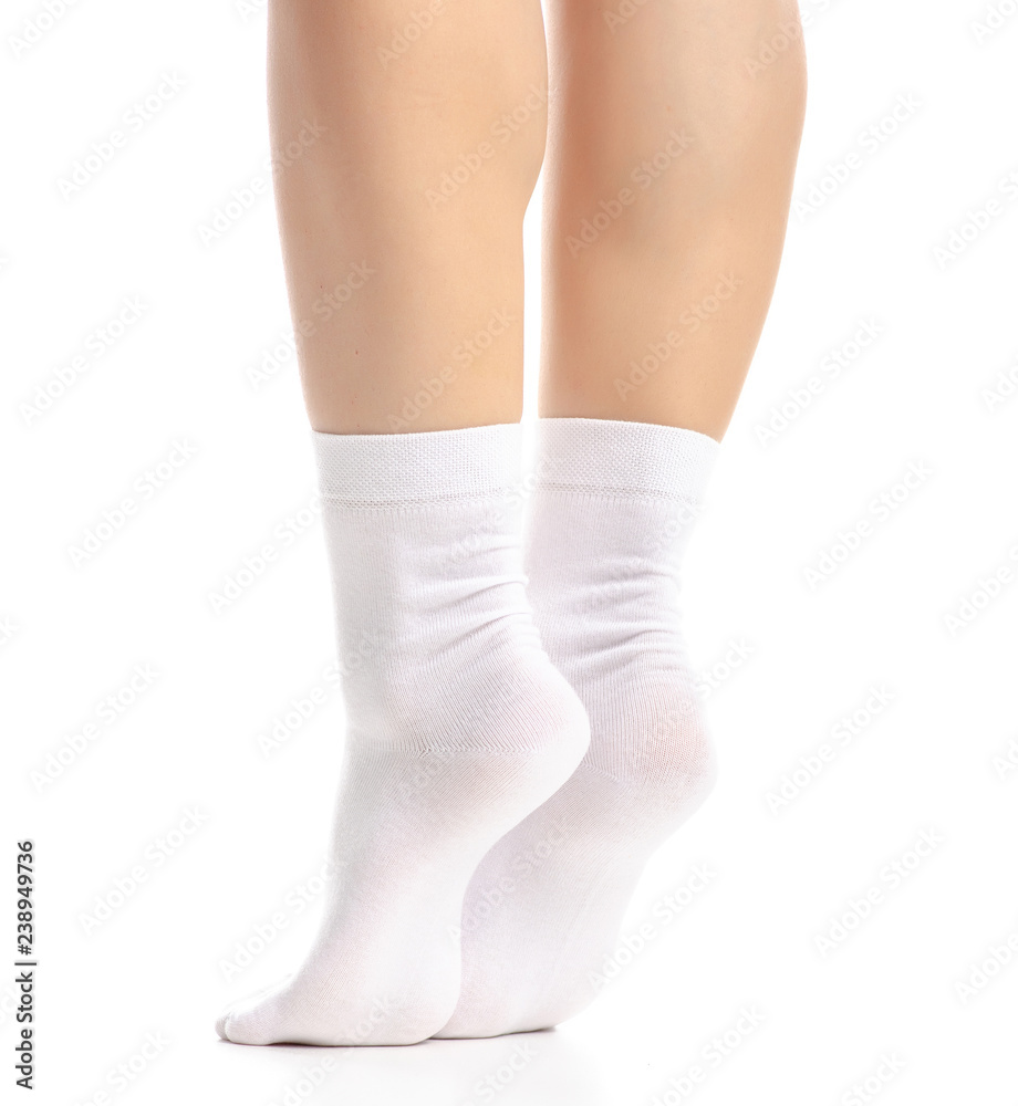 Female legs in white socks on white background. Isolation Female legs in white socks on white background. Isolation