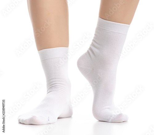Female legs in white socks on white background. Isolation