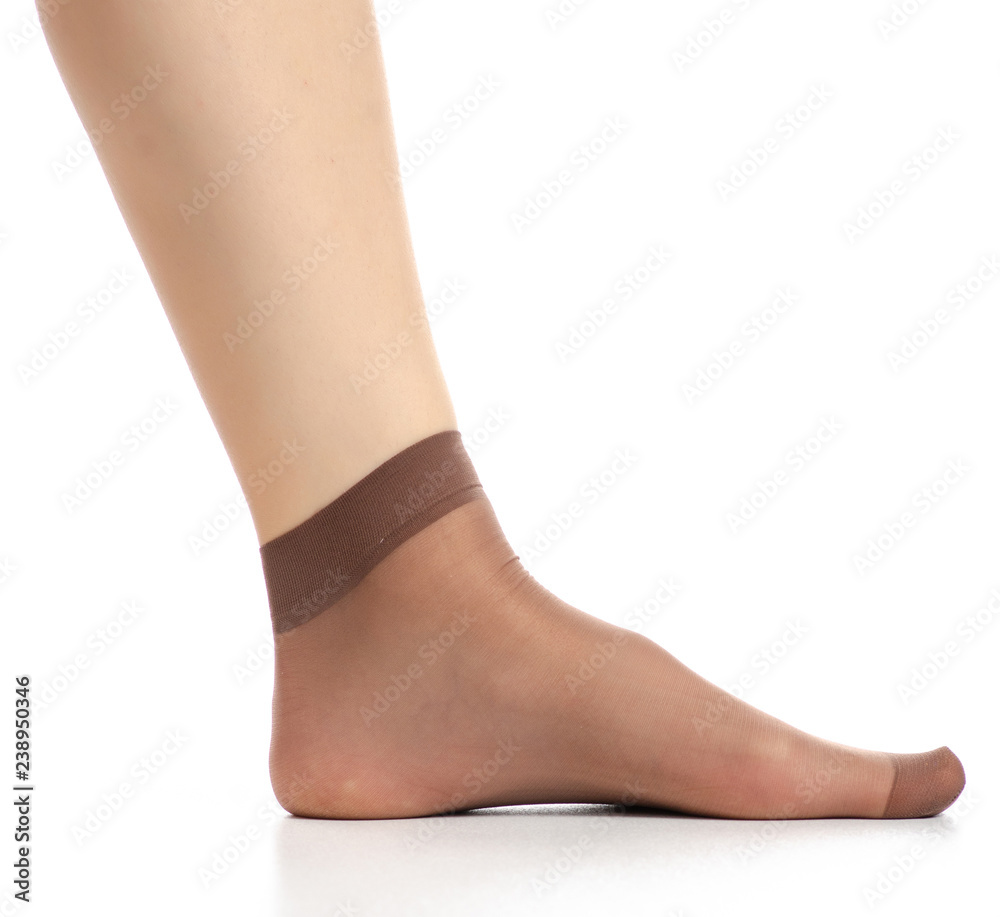 Female legs in mocha mocca nylon socks on white background. Isolation Female legs in mocha mocca nylon socks on white background. Isolation