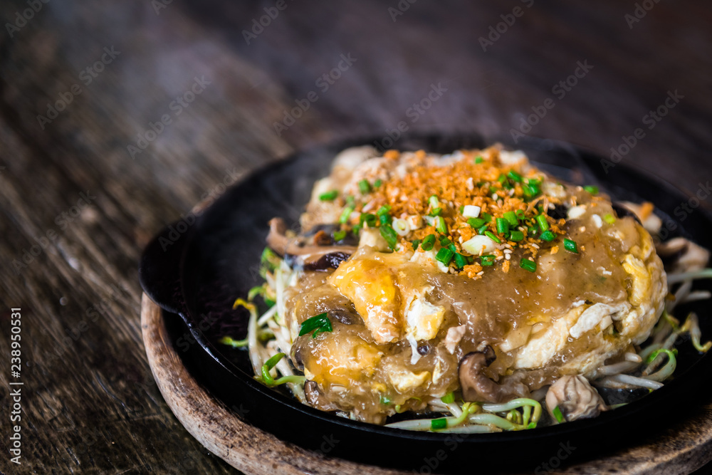 Oyster omelette in the hot pan. Thai and Chinese food.