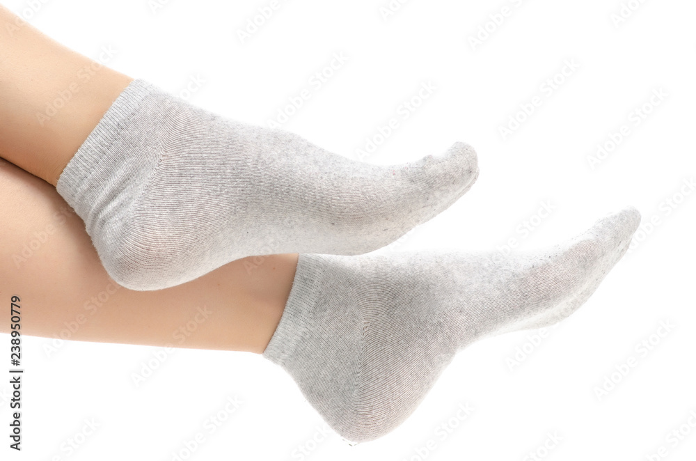 Female legs in gray socks on white background. Isolation Female legs in gray socks on white background. Isolation