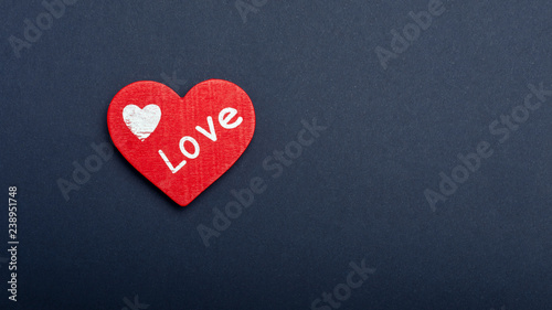 red heart on a dark paper background. The concept of Valentine's Day, the day of love, mother's day. Copy space background texture