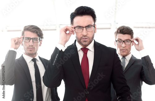 three businessmen with glasses, pretentious looking at the camera
