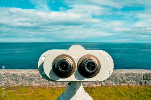 tourist prismatic in front of the sea a sunny day