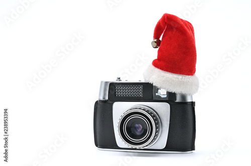 Santa Claus hat and vintage camera for photographing on a white background