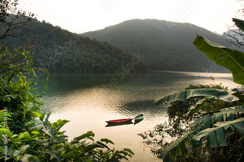 Boats around Phewa Lake and hills in Pokhara, a popular tourist destination. Taken in Nepal, December 2018.