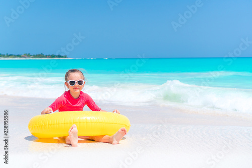 Adorable little girl having fun on the beach