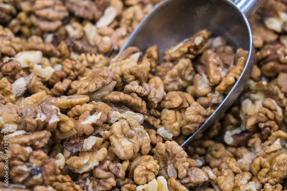 Full frame of peeled raw organic walnuts in the market. Walnut background texture