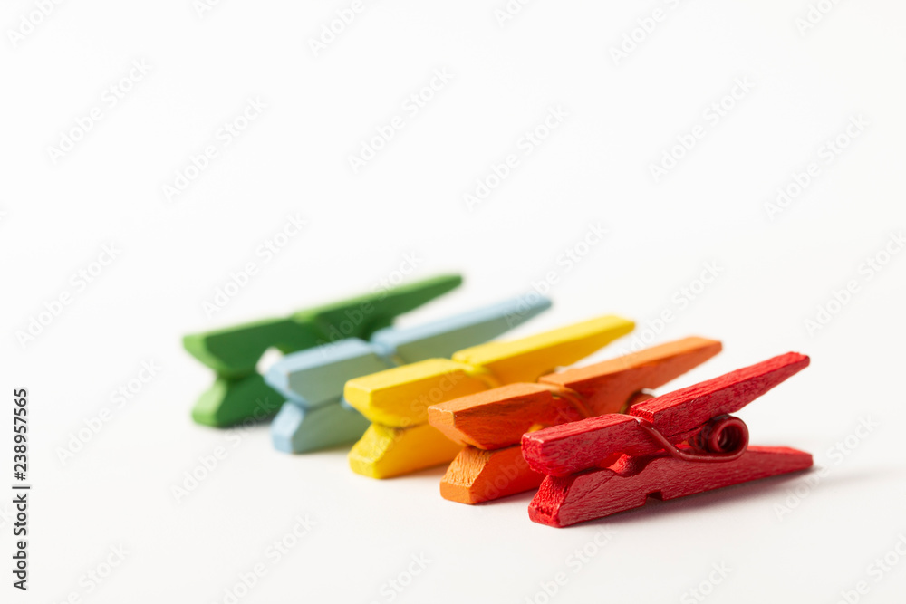 Colorful wooden clothespins on white background concept Colorful wooden clothespins on white background concept