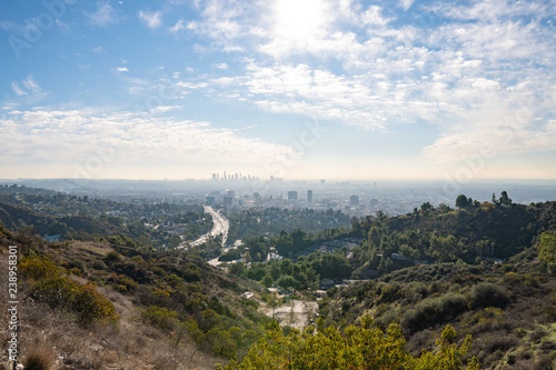 View of Los Angeles from the Hollywood Hills. Down Town LA. Hollywood Bowl. Warm sunny day. Beautiful clouds in blue sky. 101 freeway traffic.