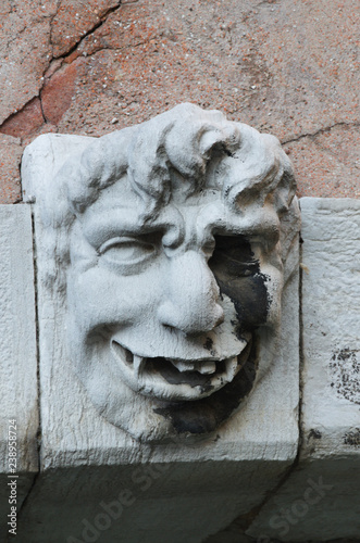 Gargoyle face on bridge Venice Italy