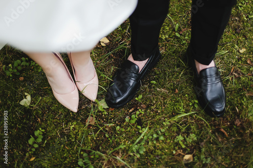 Bridal and groom wedding shoes on the background of green grass. wedding details, wedding day © paralisart