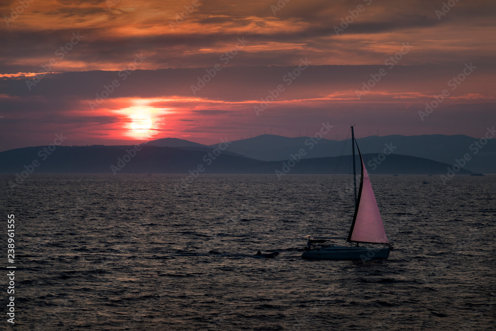 Sunset on Adriatic sea in Croatia with islands and sailing boat