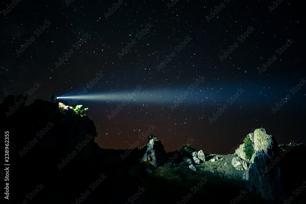 Fototapeta Exploring mountains with flashlight