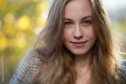 Portrait of a smiling young woman with long blond hair