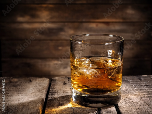 Fényképezés Whiskey glass with ice on wood