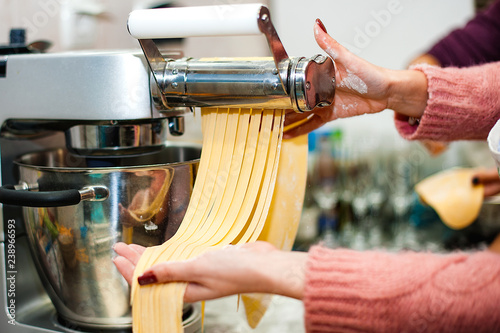 Woman hold a dough for homemade pasta