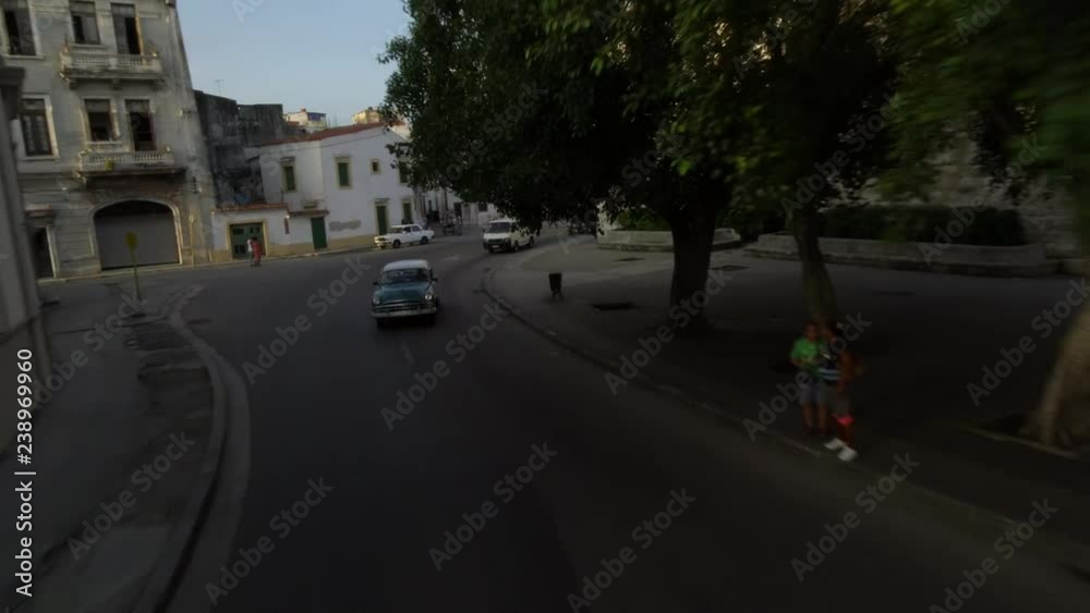 Drone aerial shot of classic 1950's American Vintage Taxi Car driving on street old Havana, Cuba Drone aerial shot of classic 1950's American Vintage Taxi Car driving on street old Havana, Cuba