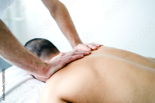Male Athlete having sport massage In The Spa