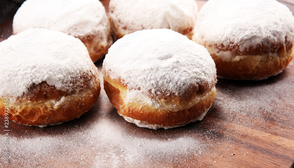 German donuts with jam and icing sugar. Carnival powdered sugar raised donuts