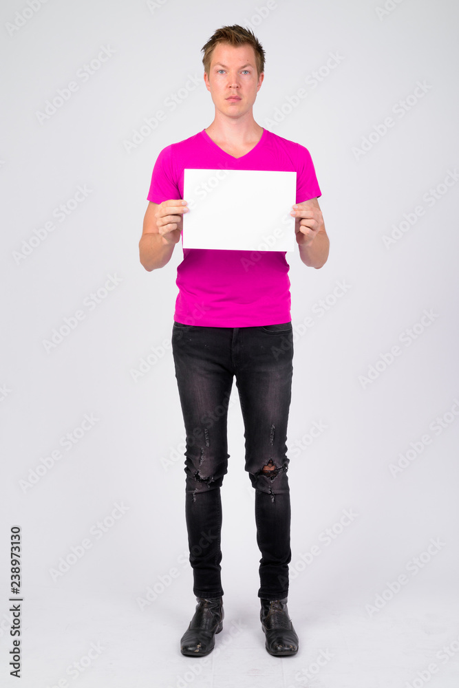 Full body shot of young handsome man holding copy space Full body shot of young handsome man holding copy space