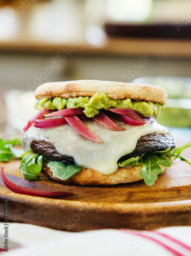 Portabella mushroom sandwich with Havarti cheese, red onions, arugula and guacamole photo