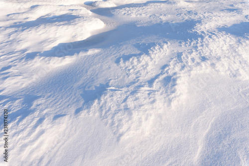 Snowdrift, wind sculpted patterns on snow surface. © ekim