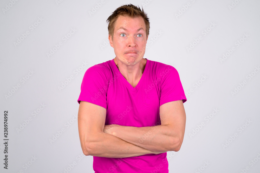 © Ranta Images - Angry young man looking upset with arms crossed