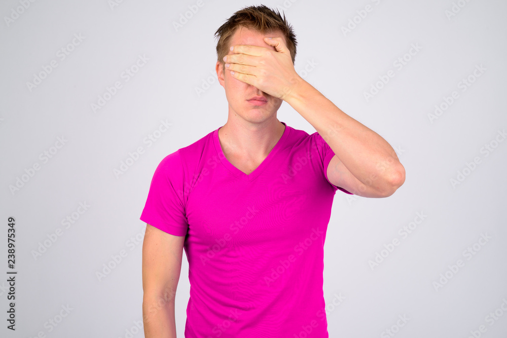 Young handsome man covering eyes as see no evil concept Young handsome man covering eyes as see no evil concept