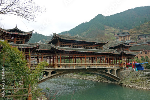 The Wooden Bridge of Qian Hu Miao Zai Village in morning mist , Guizhou province China.