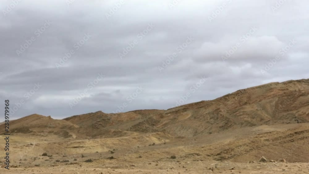 Slow motion wild landscape of Makhtesh Ramon, Ramon Crater, in the Negev desert , Israel. 4k. View from the bottom of the hollow. Slow motion wild landscape of Makhtesh Ramon, Ramon Crater, in the Negev desert , Israel. 4k. View from the bottom of the hollow.