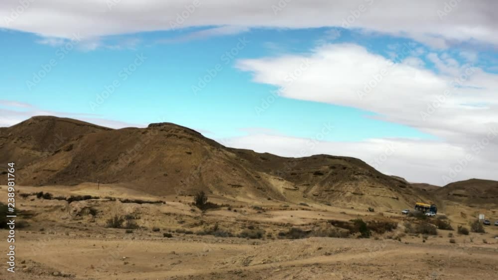 Slow motion wild landscape of Makhtesh Ramon, Ramon Crater, in the Negev desert , Israel. 4k. View from the bottom of the hollow. Slow motion wild landscape of Makhtesh Ramon, Ramon Crater, in the Negev desert , Israel. 4k. View from the bottom of the hollow.