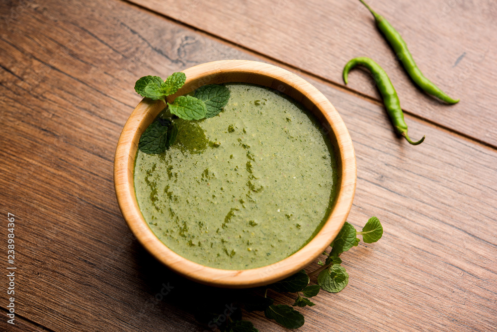 Healthy Green Mint Chutney Made with Coriander, pudina And Spices. isolated moody background. selective focus Healthy Green Mint Chutney Made with Coriander, pudina And Spices. isolated moody background. selective focus