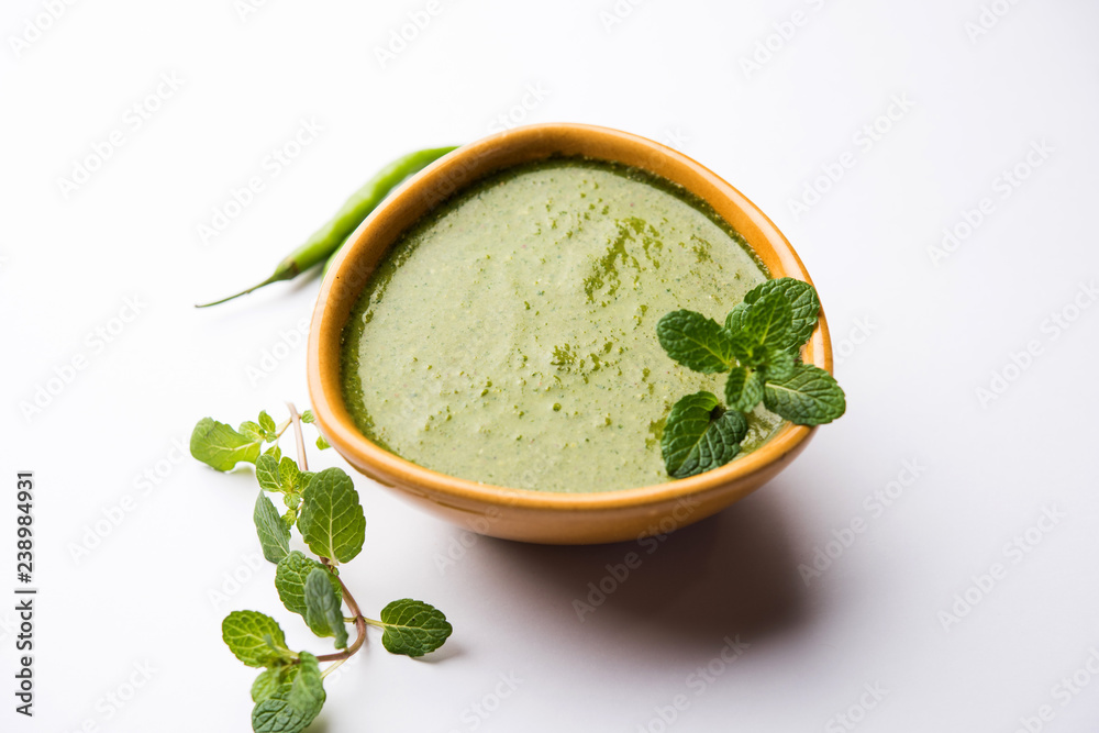 Healthy Green Mint Chutney Made with Coriander, pudina And Spices. isolated moody background. selective focus Healthy Green Mint Chutney Made with Coriander, pudina And Spices. isolated moody background. selective focus