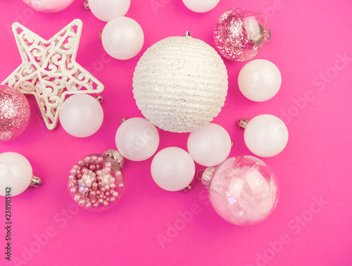 Gentle pink and white baubles on a pink background. Christmas mood. Copy space