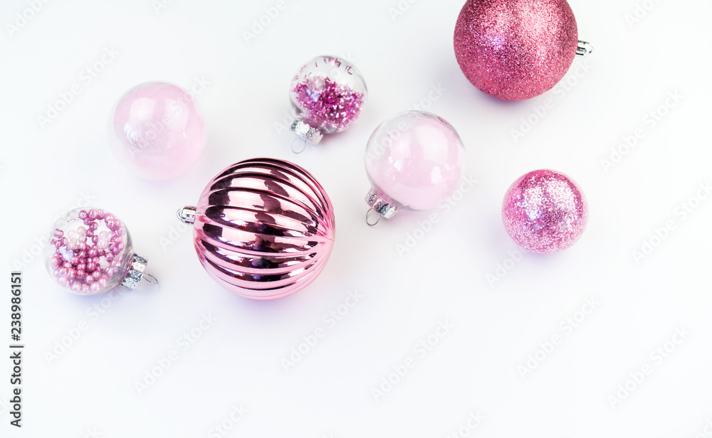 Gentle pink baubles on a white background. Christmas mood. Copy space Gentle pink baubles on a white background. Christmas mood. Copy space