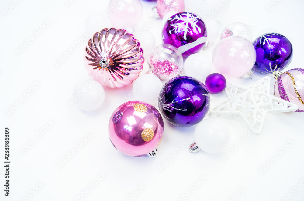 Gentle pink and purple baubles on a white background. Christmas mood. Gentle pink and purple baubles on a white background. Christmas mood.