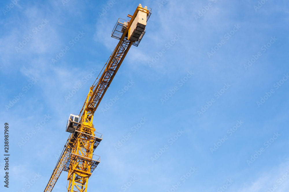 Construction industry of Engineer Business, Technology Concept with Industrial yellow cranes with blue sky ,clouds background on site building from high ground and heavy material. Construction industry of Engineer Business, Technology Concept with Industrial yellow cranes with blue sky ,clouds background on site building from high ground and heavy material.