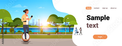 woman ride electric mono wheel using smartphone girl modern personal transport outdoor nature city urban park cityscape sunset horizontal copy space
