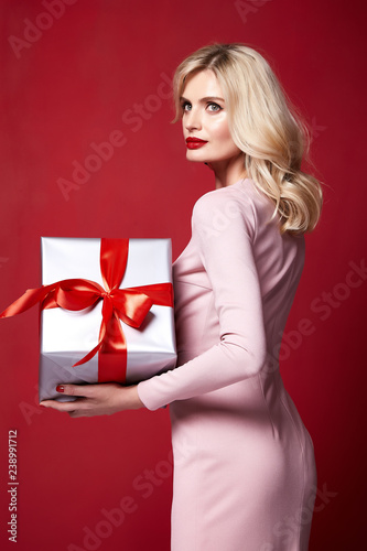 Sexy pretty lady fashion model beautiful woman wear style skinny knitted dress celebration happy holidays merry Christmas Eve New Year party St. Valentine's Day hold gift box present surprise makeup. © indiraswork