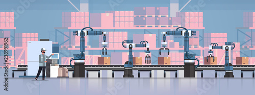 man engineer controlling conveyor belt line robotic hands factory automation production manufacturing process concept warehouse storage interior horizontal